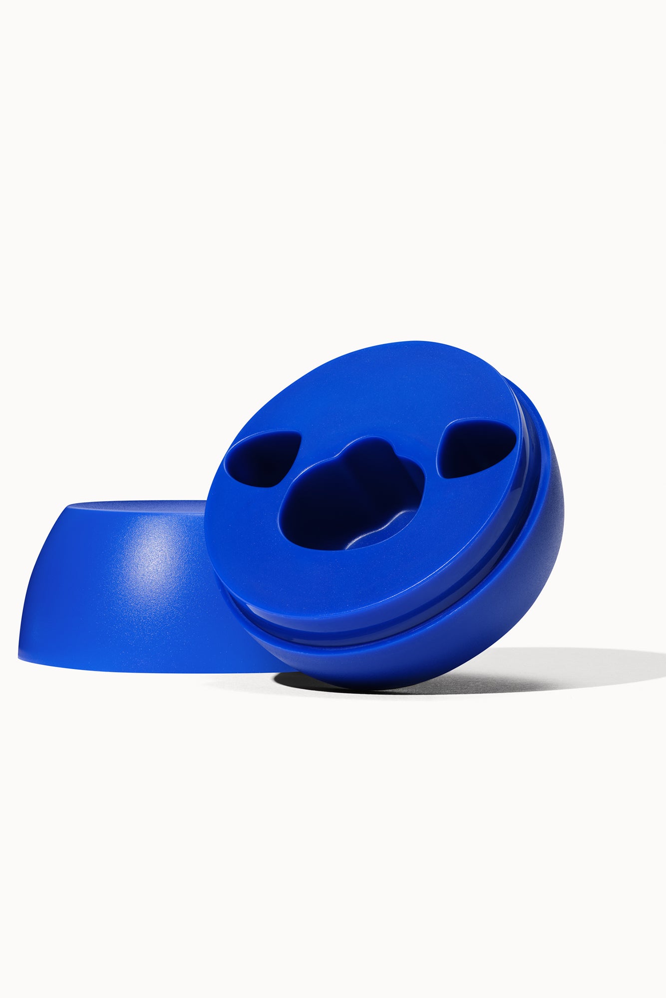 Blue charging base for Eva sex toy, on off-white background.
