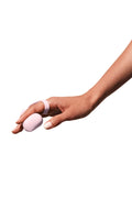 Quartz | A light pink finger vibrator attached to a silicone finger holder.