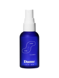 Hand + Vibe Cleaner | Seamless | Ablue 2floz bottle with Dame's bright blue logo on beige background.