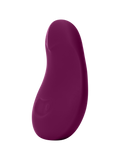 Plum | Seamless | A deep purple, pebble shaped vibrator Pom from the side on an off-white background
