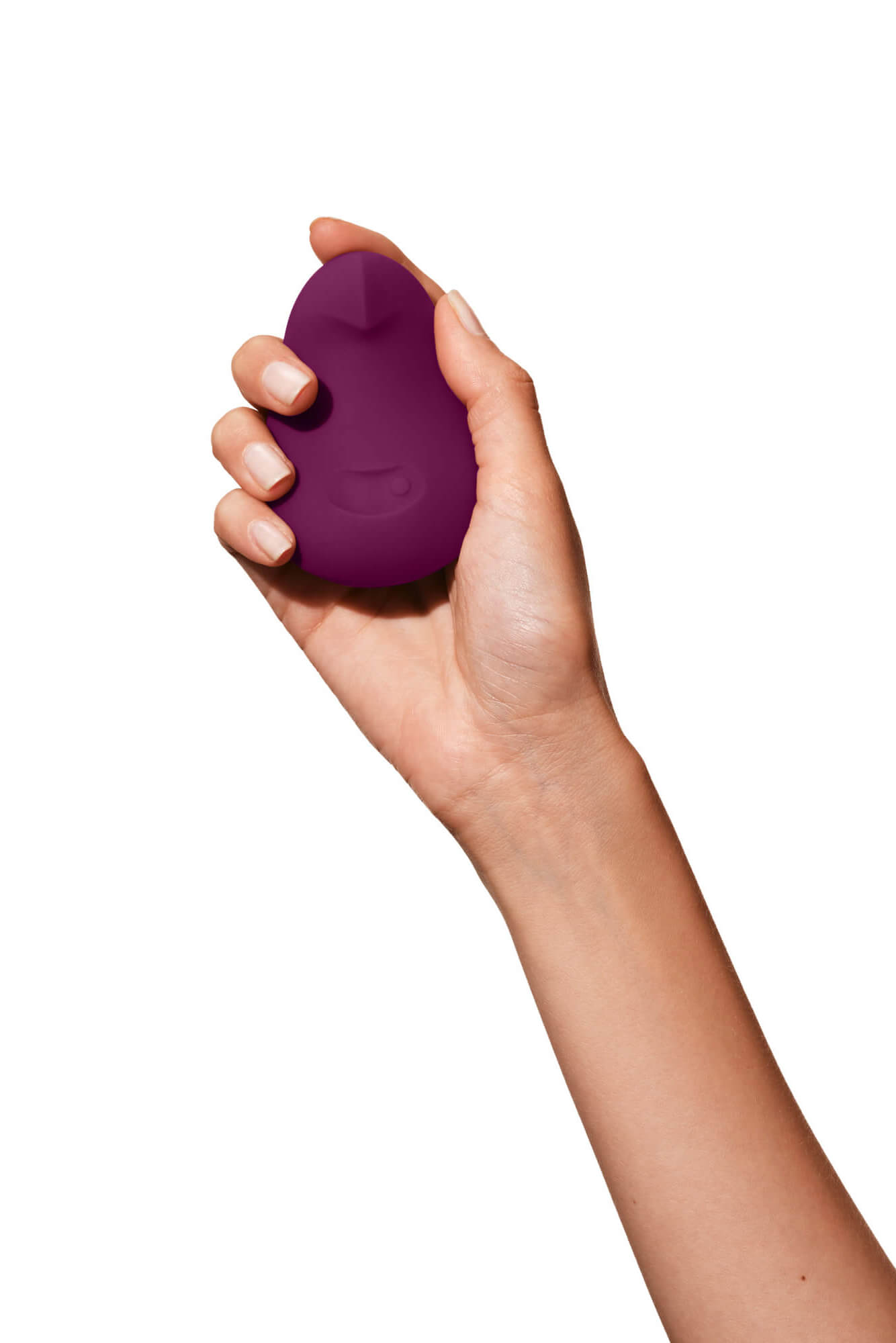 Plum | A deep purple, pebble shaped vibrator on beige background