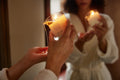 Melt Together | Dame Massage Oil Candle lighted and being poured over the palm of a hand